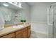 Well-lit bathroom featuring a bathtub, a shower, and a vanity with countertop and plants at 10184 Park Meadows Dr # 1406, Lone Tree, CO 80124