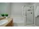 Bathroom featuring a bathtub and a shower, with a vanity countertop and plants at 10184 Park Meadows Dr # 1406, Lone Tree, CO 80124