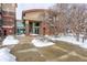 Exterior view of a brick building with snow around the entrance at 10184 Park Meadows Dr # 1406, Lone Tree, CO 80124