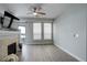 Bright living room with fireplace and ceiling fan, featuring hardwood floors and a large window at 10184 Park Meadows Dr # 1406, Lone Tree, CO 80124