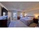 Spacious bedroom with large bed, dresser, and natural light from two windows at 1922 S Ivory Way, Aurora, CO 80013