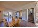 Inviting dining area with staircase access and ample natural light from a large window at 1922 S Ivory Way, Aurora, CO 80013