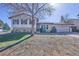 Split-level home with brick and siding and an attached two car garage at 1922 S Ivory Way, Aurora, CO 80013