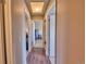 Hallway with hardwood floors that leads to rooms with white doors at 1922 S Ivory Way, Aurora, CO 80013