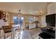 Eat-in kitchen with sliding glass door, ample sunlight, white cabinets and tile floors at 1922 S Ivory Way, Aurora, CO 80013