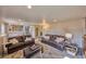 Spacious living room featuring leather sofas, a rug and a staircase at 1922 S Ivory Way, Aurora, CO 80013