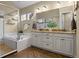 Spa-like bathroom with a deep soaking tub, dual vanity, and elegant tile work at 6878 Northstar Ct, Castle Rock, CO 80108