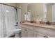 Bathroom features a dual granite vanity, white cabinets and a shower with a bathtub at 6878 Northstar Ct, Castle Rock, CO 80108