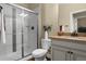 Bright bathroom featuring a tiled shower with glass doors and granite countertops on a classic vanity at 6878 Northstar Ct, Castle Rock, CO 80108