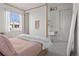 Bedroom with white walls, light gray carpet, a writing desk, a large framed mirror and natural light from a window at 6878 Northstar Ct, Castle Rock, CO 80108