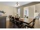 Dining room with dark wood table, hardwood floors and view into a sitting room and stairway at 6878 Northstar Ct, Castle Rock, CO 80108