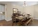 Dining room with wood table, bench, hardwood floors, and chandelier at 6878 Northstar Ct, Castle Rock, CO 80108