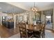 Dining room with wood table, chandelier, and access to kitchen, living room, and backyard patio at 6878 Northstar Ct, Castle Rock, CO 80108