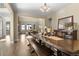 Dining room with long wood table, bench, hardwood floors, mirror, and open access to the living room at 6878 Northstar Ct, Castle Rock, CO 80108