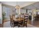 Bright dining room with wood table, chandelier, large window and access to the kitchen at 6878 Northstar Ct, Castle Rock, CO 80108