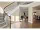 Inviting foyer with hardwood floors, staircase, and open view to the living spaces at 6878 Northstar Ct, Castle Rock, CO 80108