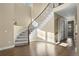 Bright foyer with hardwood floors, a curved staircase, and elegant design at 6878 Northstar Ct, Castle Rock, CO 80108