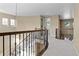 Open hallway with elegant railings leads to various rooms, creating a seamless flow throughout the home at 6878 Northstar Ct, Castle Rock, CO 80108