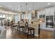 Bright kitchen featuring a large center island, breakfast bar, stainless appliances and hardwood floors at 6878 Northstar Ct, Castle Rock, CO 80108