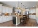 Bright kitchen featuring a center island, stainless appliances, light cabinets, and hardwood floors at 6878 Northstar Ct, Castle Rock, CO 80108