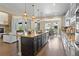 Bright kitchen featuring a center island, stainless appliances, hardwood floors, and access to the living room at 6878 Northstar Ct, Castle Rock, CO 80108