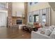 Bright living room with a stone fireplace, hardwood floors, and large windows at 6878 Northstar Ct, Castle Rock, CO 80108