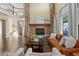 Inviting living room featuring a stone fireplace, hardwood floors, and natural light at 6878 Northstar Ct, Castle Rock, CO 80108