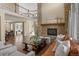 Spacious living room with a stone fireplace, hardwood floors, and an open layout at 6878 Northstar Ct, Castle Rock, CO 80108