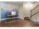 Home office with a custom painted blue mountain mural, hardwood floors, a wooden desk and steps to an upper level at 6878 Northstar Ct, Castle Rock, CO 80108