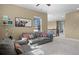 Inviting sitting area with comfortable sofa, decorative pillows, and large windows providing natural light at 6878 Northstar Ct, Castle Rock, CO 80108
