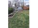 Spacious backyard featuring a relaxing hammock, storage sheds, raised garden beds, and ample green space at 1519 S Lowell Blvd, Denver, CO 80219
