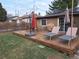 Backyard deck furnished with chairs and lounge chairs, complemented by an umbrella and string lights for outdoor enjoyment at 1519 S Lowell Blvd, Denver, CO 80219