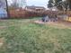 Spacious backyard featuring a fire pit seating area, firewood storage, and ample green space for outdoor activities at 1519 S Lowell Blvd, Denver, CO 80219