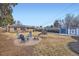 Backyard featuring a fire pit, play area, storage shed, and mature landscaping at 1519 S Lowell Blvd, Denver, CO 80219