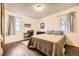 Bright bedroom featuring hardwood floors, neutral walls, and a small desk space at 1519 S Lowell Blvd, Denver, CO 80219