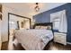 Comfortable bedroom with an attached sitting room and decorative stone accent wall at 1519 S Lowell Blvd, Denver, CO 80219