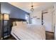 Bright bedroom featuring a dark wood headboard, stylish light fixture, and closet at 1519 S Lowell Blvd, Denver, CO 80219