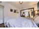 Cozy bedroom showcasing a large bed, unique wall decor, and view to a sitting room at 1519 S Lowell Blvd, Denver, CO 80219