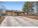 Inviting home featuring a spacious driveway and a well-manicured front yard at 1519 S Lowell Blvd, Denver, CO 80219