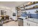 Updated kitchen featuring stainless steel appliances, a new sink and stylish wooden shelves at 1519 S Lowell Blvd, Denver, CO 80219