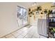 Bright laundry room with yellow walls, decorative plants, storage shelves, and a sliding glass door to the backyard at 1519 S Lowell Blvd, Denver, CO 80219