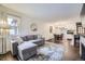 Open-concept living room with hardwood floors, a comfortable couch and a dining area at 1519 S Lowell Blvd, Denver, CO 80219