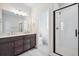 Bathroom featuring double vanity, glass shower and tile floors at 1263 Rhett Dr, Erie, CO 80026