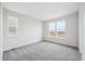 Bright bedroom with windows, neutral paint, and carpeted floors at 1263 Rhett Dr, Erie, CO 80026