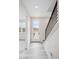 Inviting entryway with light gray wood flooring and a staircase with modern black steel railings at 1263 Rhett Dr, Erie, CO 80026