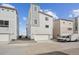 Modern townhome featuring a two-car garage and driveway at 1263 Rhett Dr, Erie, CO 80026