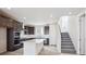 Modern kitchen with dark wood cabinets, an island, and stainless steel appliances at 1263 Rhett Dr, Erie, CO 80026