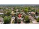 Aerial view of the property in a quiet neighborhood with mature trees at 7046 W 62Nd Pl, Arvada, CO 80003