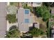 Aerial view of a home with solar panels, a lush backyard, and mature trees at 7046 W 62Nd Pl, Arvada, CO 80003