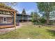 Lovely backyard with a covered deck, mature trees and a spacious lawn at 7046 W 62Nd Pl, Arvada, CO 80003